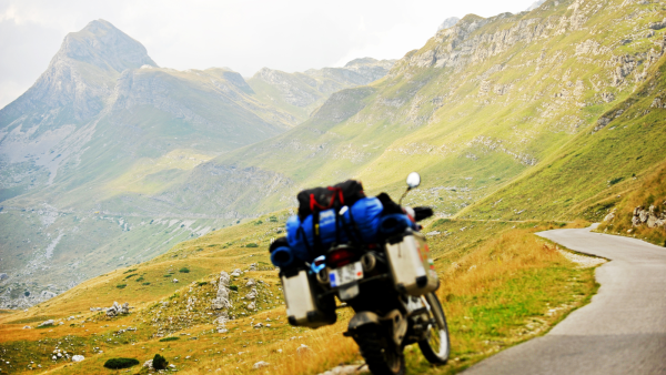 Motorcycle parked by the side of a mountain road